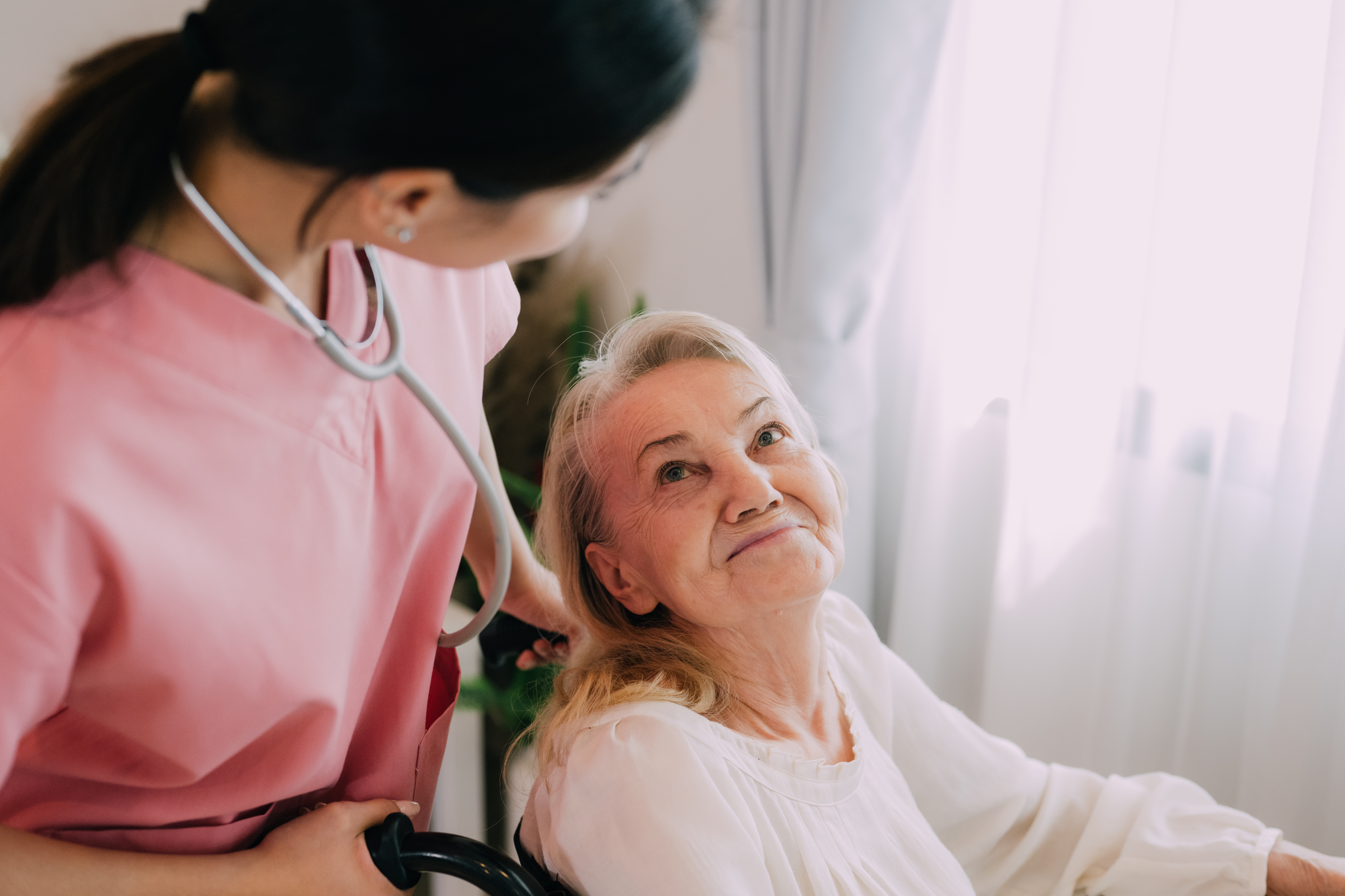Happy senior woman talking with female caregiver aurora-home-care-services-ne